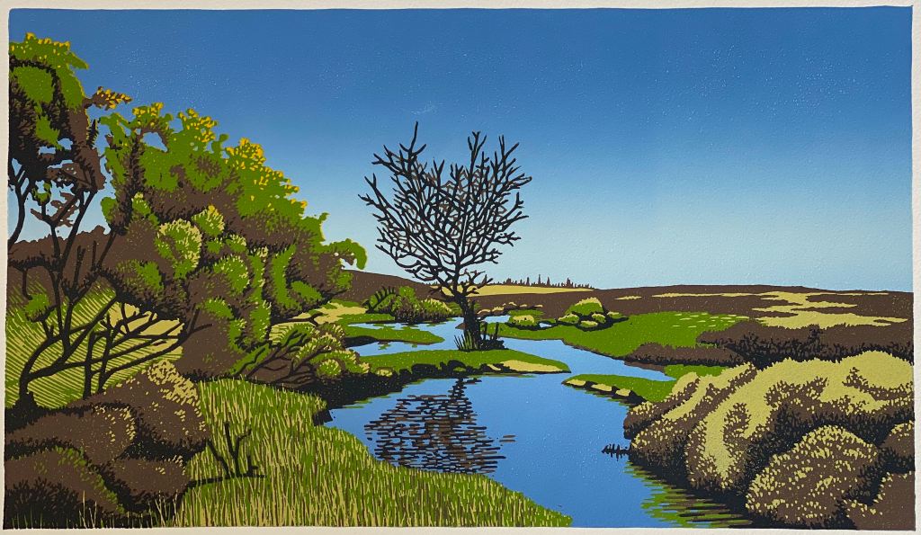 A linocut print of a landscape with bare tree next to a stream and gorse bushes