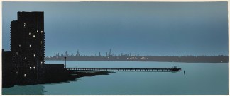 A view across a river estuary at dusk. In the distance is the grey outline of industrial chimneys dotted with points of light. In the foreground is the silhouette of a tower block and a long jetty.